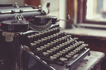 old typewriter with round keys by a window, natural light