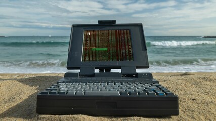 laptop computer on a beach with data and code on screen - 801260558