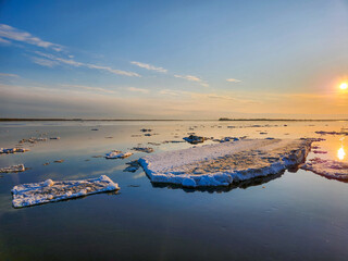 a large ice floe during an ice drift on the Severnaya Dvina River in Arkhangelsk against the...