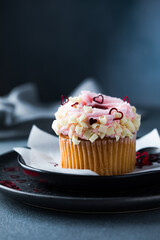 Cupcakes with cream cheese and strawberries. Cupcakes for valentine's day on a concrete table