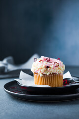 Cupcakes with cream cheese and strawberries. Cupcakes for valentine's day on a concrete table