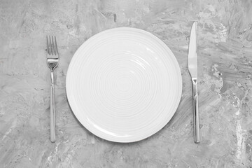 Elegant setting with shiny cutlery on grey table, top view