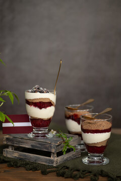 Selective focus rye bread traditional Latvian desert with cream and cranberries front view vertical