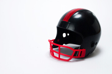 Red and black miniature american football helmets with white background