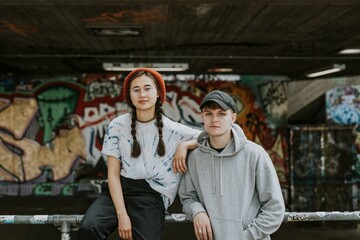 Cool friends in streetwear fashion at skate park