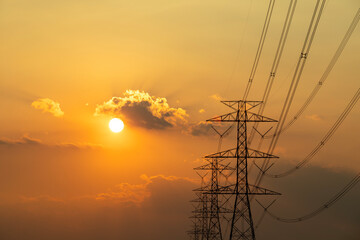 Silhouette of electricity transmission pylon. high-voltage power lines. high voltage post during...