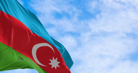 The national flag of Azerbaijan waving in the wind on a clear day.