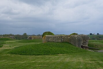 Longues-sur-Mer, France - Apr 26, 2024: German Longues-sur-Mer battery during Second World War. It is the only one in the region to have kept its guns. Rainy spring day. Selective focus.