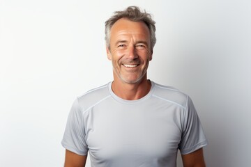 Obraz premium Portrait of a smiling man in his 50s sporting a breathable mesh jersey in front of white background