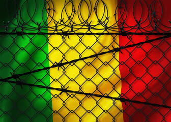 Mali flag behind barbed wire and metal fence