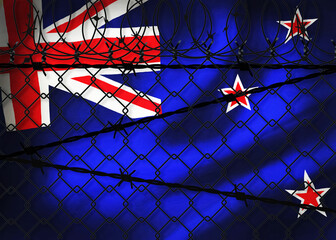 New Zealand flag behind barbed wire fence