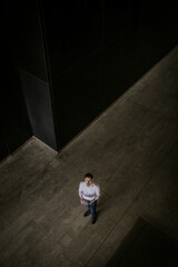 Businessman holding tablet, looking upward