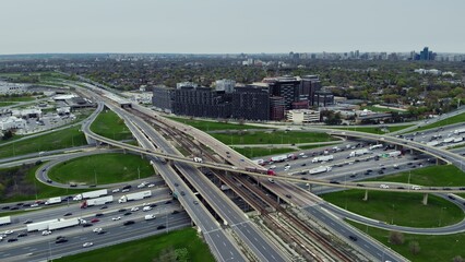 Busy urban roads intersecting, aerial perspective, essence of city commuting. Infrastructure maze: Aerial perspective of serpentine roadways teeming with cars in city commute. Highway concept