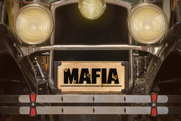 Front view of a black vintage American car with Mafia license plate
