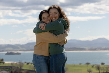 friends hugging each other tightly after a long time without seeing each other