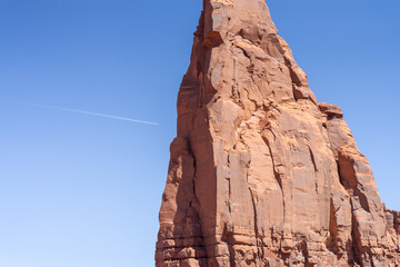 Contrail over Red Rock Monolith