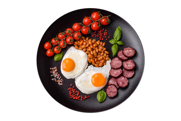 English breakfast with fried eggs, bacon, beans, tomatoes, spices and herbs
