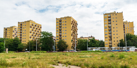Yellow Soviet style concrete apartment buildings with rusty balconies and grafitti. This urban...