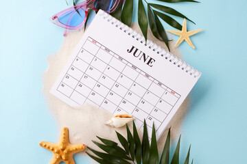 June calendar amidst beach-themed elements, suggesting the perfect time to plan for summer...