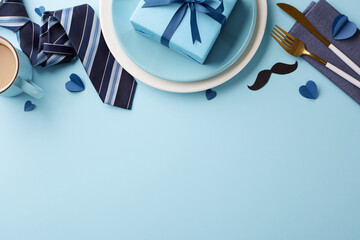 Blue-themed Father's Day dining setup featuring thoughtful touches like a gift box and a tie,...
