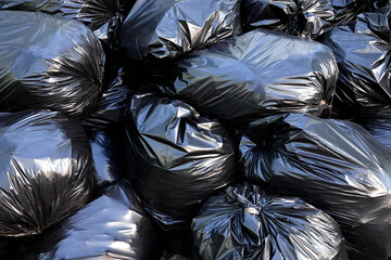 Lot black filled garbage bags as background close-up