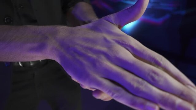 Naipe Ace Spade. Jugador o mago lanzando y levitando cartas de p&oacute;quer a mano. Vista frontal. Primer plano y tono oscuro