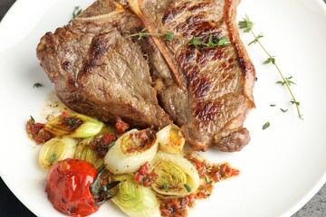 Delicious fried beef meat and vegetables on plate, closeup
