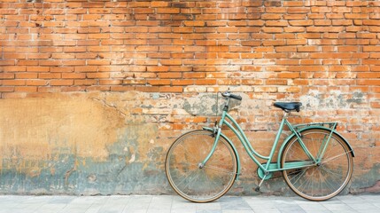 Fototapeta na wymiar bicycle leaning against brown brick wall with copy space, vintage color tone. world bicycle day background concept.