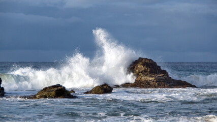 Waves breaking over rocks just off the beach in Zipolite, Mexico