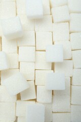White sugar cubes as background, top view