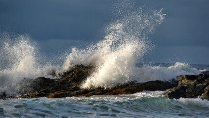Waves breaking over rocks just off the beach in Zipolite, Mexico