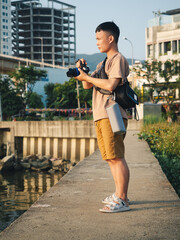 Concentrated Young Asiatic Photographer Exploring Urban Landscapes in Vietnam