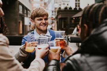 Diverse friends drinking beer in plastic cups