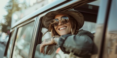 One gorgeous Caucasian woman hanging out a car window on a road trip. Lovely youthful hipster with arm tattoos, cap, sunglasses, and automobile driving. - Powered by Adobe
