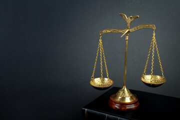 Scales and books on jurisprudence on a wooden background. Legal and law concept.