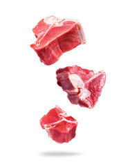 Raw beef meat steaks in the air on a white background