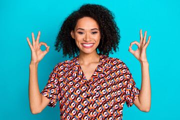 Photo of cool girly lady wear print shirt showing two okey gestures empty space isolated blue color background
