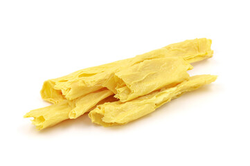 Tofu skin on a white background. Dried yuba sticks or Fuzhu on white background. Tofu skin. dried bean curd.