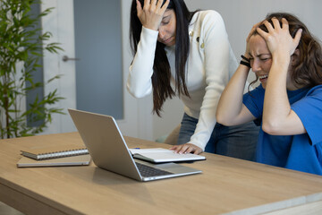 frustrated and desperate coworkers while working at home with their laptop