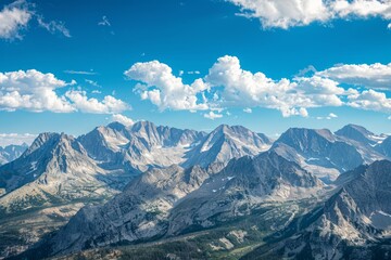 Fototapeta premium Nature's Tapestry: Blue Skies, Floating Clouds, and Majestic Mountains Painting a Breathtaking Scene.
