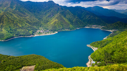 Fototapeta na wymiar Aerial view of lush green forest surrounding a volcanic lake (Lake Saiko, Yamanashi, Japan)
