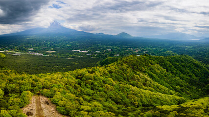 Aerial view of a cloud covered Mount Fuji and the "Sea of Trees" in Yamanashi, Japan