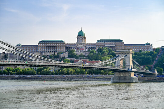 Famous Szechenyi Lanchid Chain Bridge over the Danube with a view of the Budapest Buda Castle, Royal Palace, Budavari Palota, Budapest, Hungary in summer with a blue sky