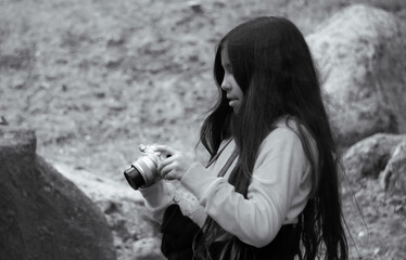 Side view of a girl holding a camera