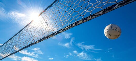 Beach volleyball  ball and net under blue sky, symbolizing summer relaxation and coastal sports