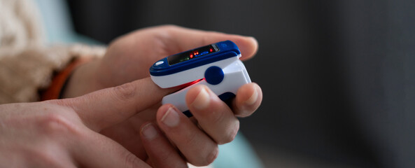 Pulse oximeter on a male finger. Sick man using oximeter. Healthy Concept.
