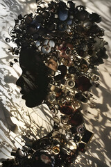 Masterful Piece of Shadow Art Depicting Woman's Profile Crafted from Everyday Objects