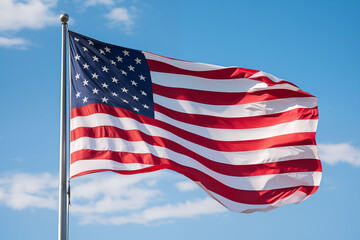 American flag waving in the breeze against a clear blue sky