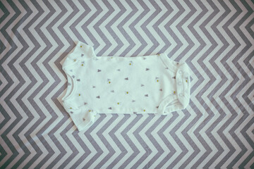 baby clothes in crib