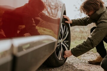 Man checking car tire photo
